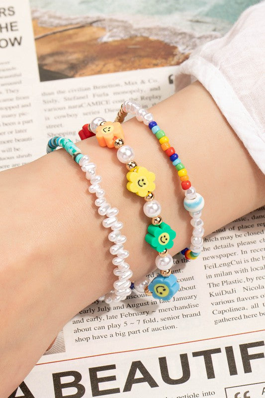 Smiley face and pearl layered bracelet